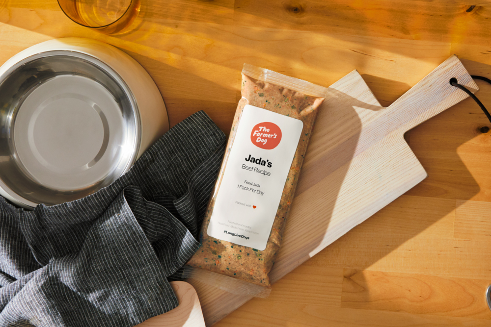 The Farmer's Dog food package on a wooden cutting board in kitchen