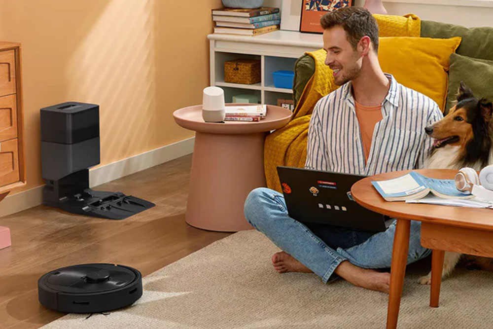 Roborock pet vacuum in a living room, with man and dog