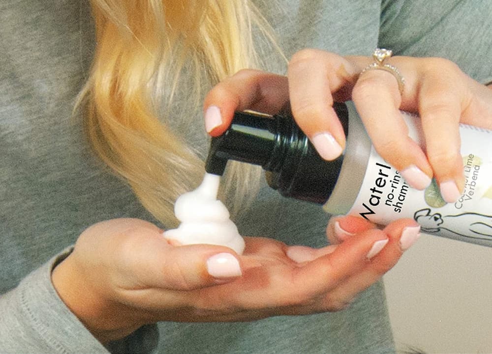 Woman using dog dry shampoo