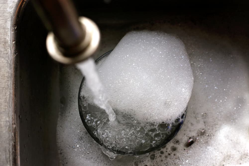 Hot soapy water washing bowl in the sink