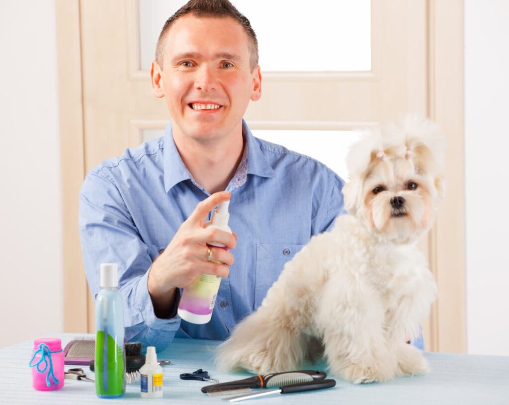 man with spray cologne for dog