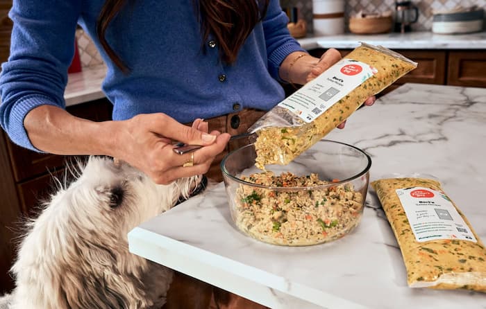 understanding dog food labels as a dog looks at his food being prepared
