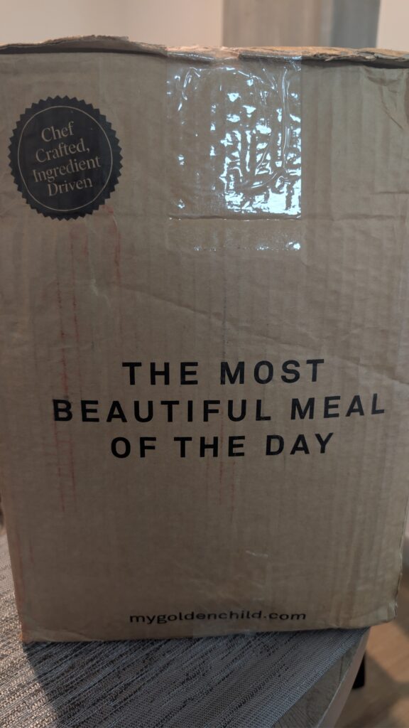 Golden Child delivery box printed with The Most Beautiful Meal of the Day